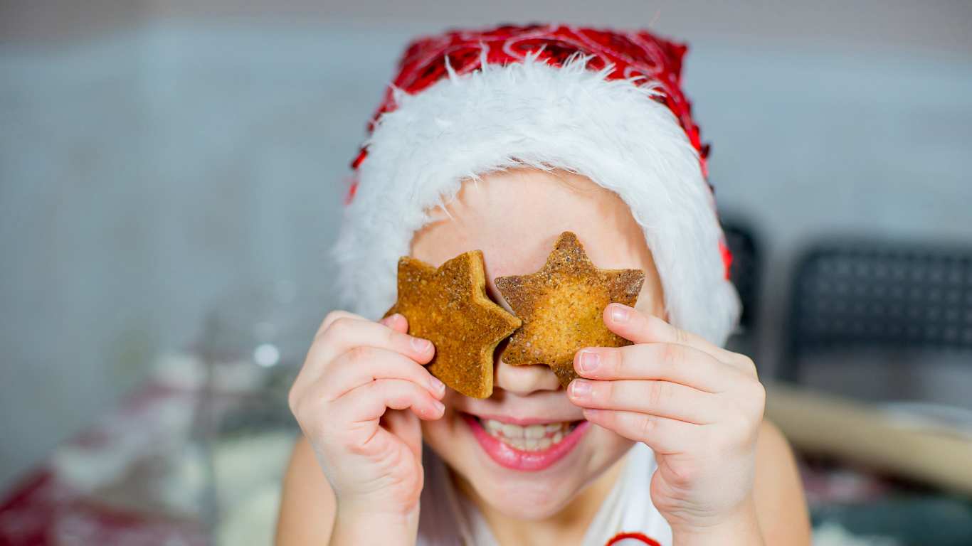 Girl holding cookies in front of eyes