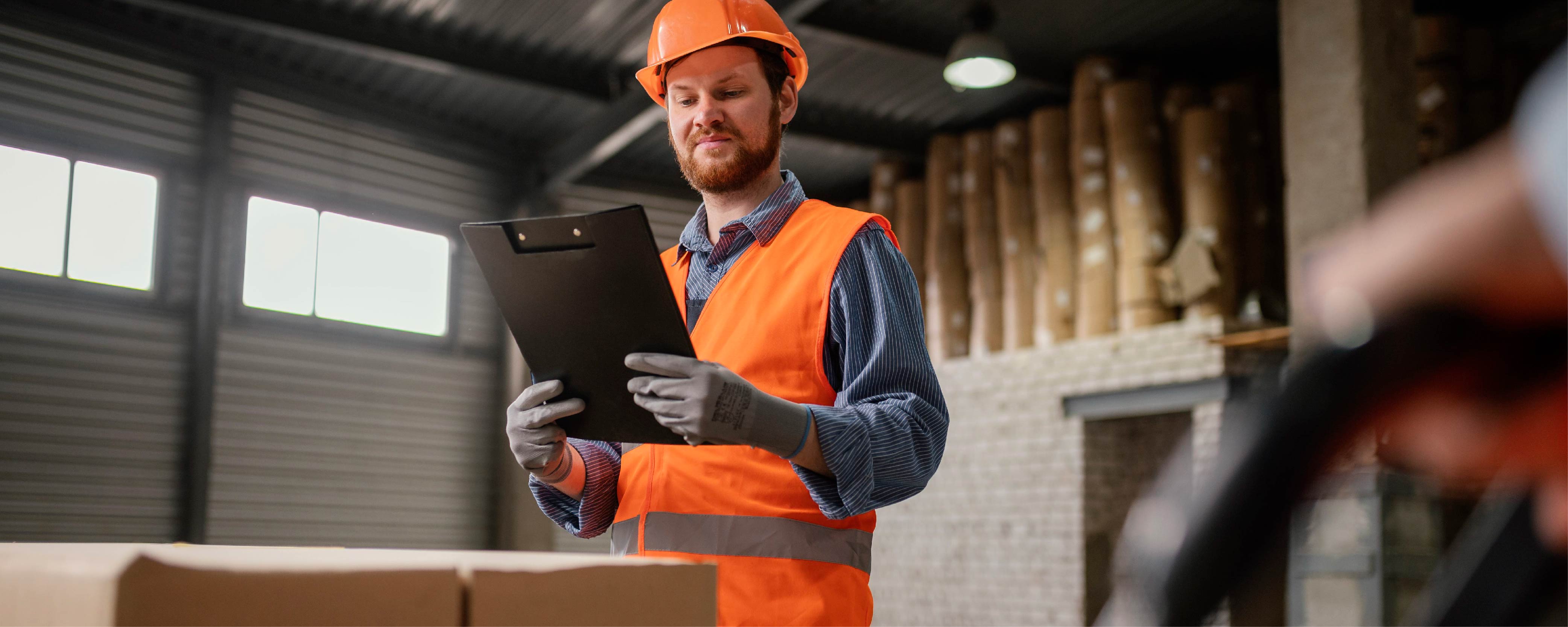 A business man with a hard hat using a container for storage