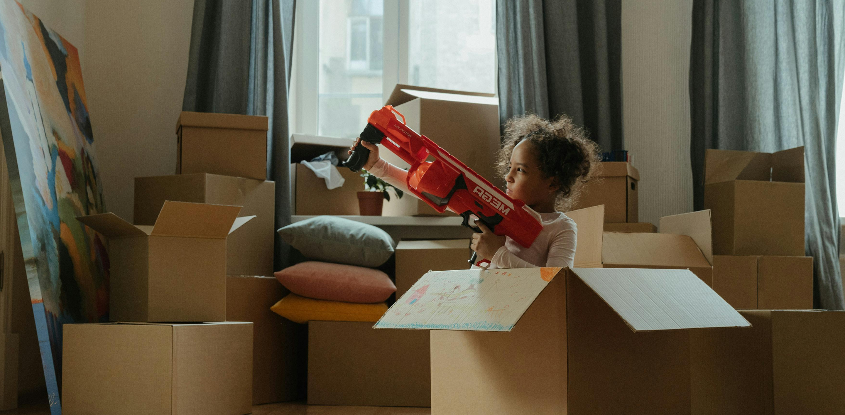 A child playing in cardboard boxes