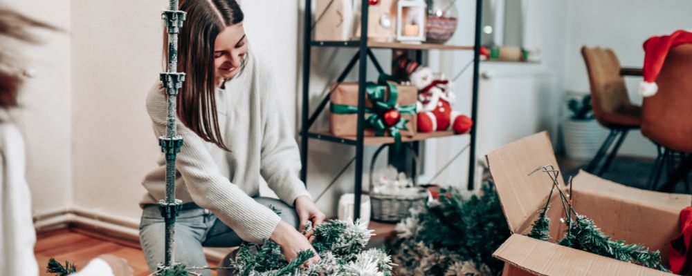 A woman wrapping up individual ornaments