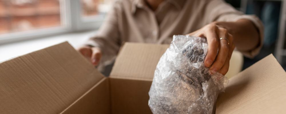 An owner carefully packing collectables of high value into a box